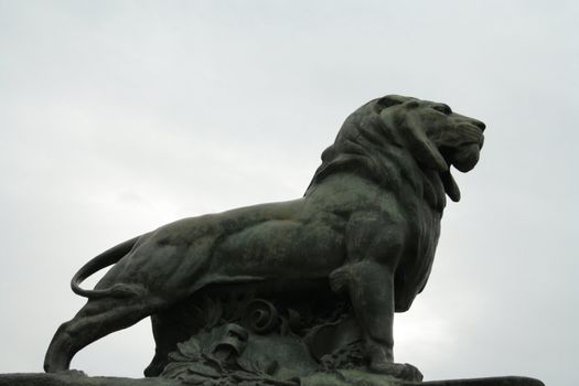 A stone lion statue at the Retiro Gardens in Madrid.