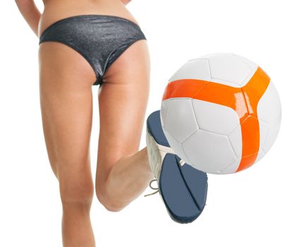 Beautilful woman in bikini posing with soccer ball. Isolated on white