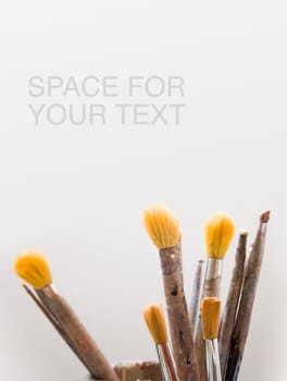 Paint brushes with plenty of copy space.