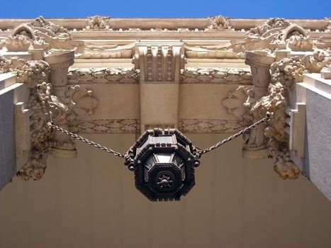      Bottom view of a lantern hanging from the columns of the Madrid Major House, commonly known as Saint Mary of the Telecommunications.     