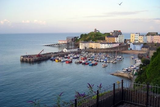 Tenby's dock with the high tide in a summer sunset.