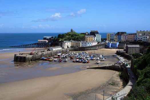 Tenby's dock with low tide in a summer day.