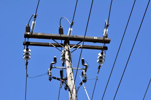 Electrical power pole with associated distribution lines and components.