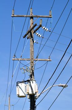 Electrical power pole with associated distribution lines and components.