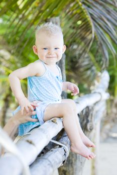 toddler sitting on palm tree, Sauteurs Bay, Grenada