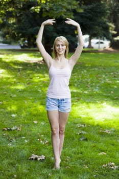 Pretty Teen Girl in Park Doing a Ballet Pose