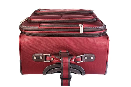 The red closed suitcase of the average size is convenient for business trips and short rest.