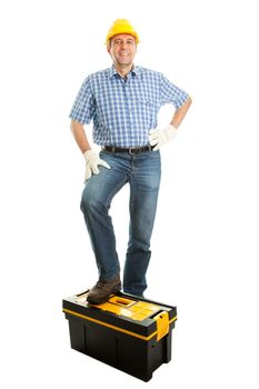 Confident repairman wearing hard hat and standing on toolbox. Isolated on white