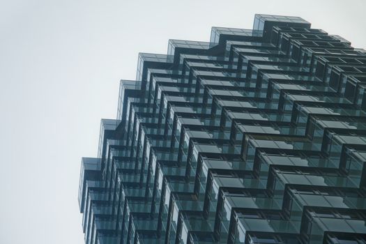 Black multifacet and reflective building on a sky background.