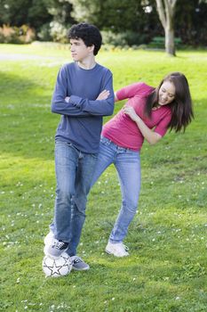 Portrait of Teen Boy with Soccer Ball Ignoring Teen Girl