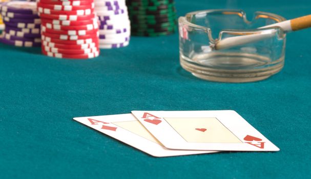 Hearts and as of diamonds on a table for game in poker.