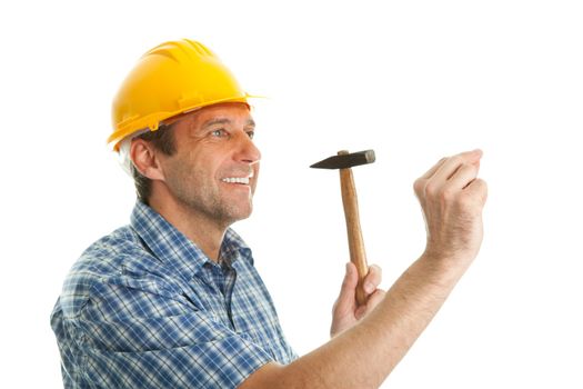 Confident worker wearing hard hat and hammering in. Isolated on white