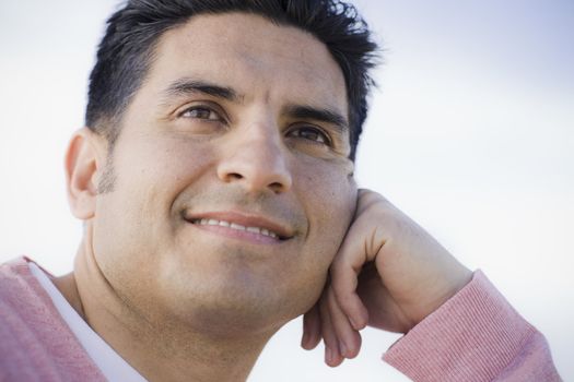 Portrait of Smiling Man Resting on his Hand Outdoors