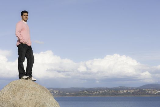 Portrait of Man Standing on Rock Overlooking Lake