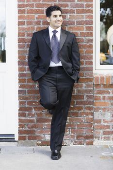 Smiling Man Wearing a Black Suit and Tie