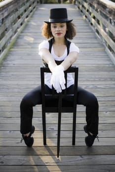 Jazz Dancer Sitting in Chair on Bridge