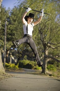 Jazz Dancer with Cane Jumping on Tree Lined Pathway