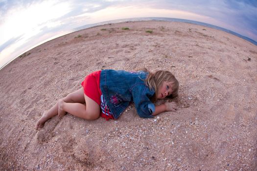 people series: little girl are lay on sea sand