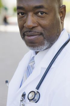 African American Doctor Standing Outside Looking To Camera