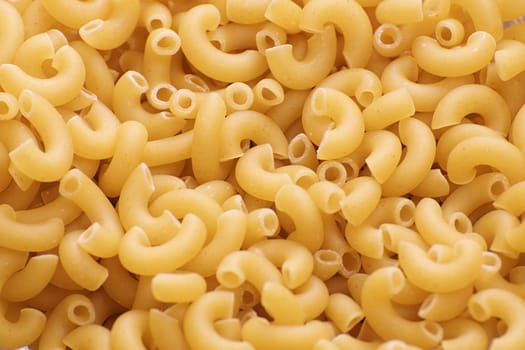 Uncooked macaroni noodles used as a carbohydrate background