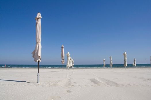 white umbrellas on the beach