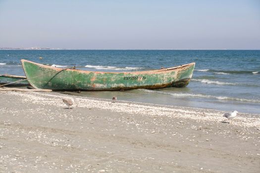 green boat on the beach
