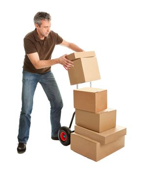 Delivery man staking packages on hand truck. Isolated on white