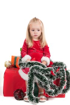 Christmas toddler with present boxes, studio shot