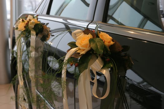 Two bouquets fixed to car doors.