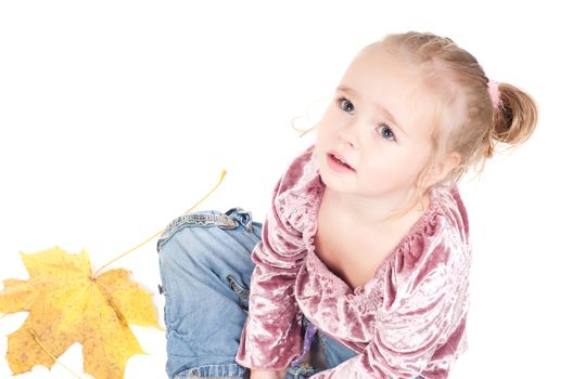 Shot of toddler playing with muple leaves in studio