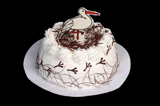 White cake with stork in white plate on the black background.
