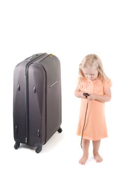 Shot of little girl and suitcase in studio