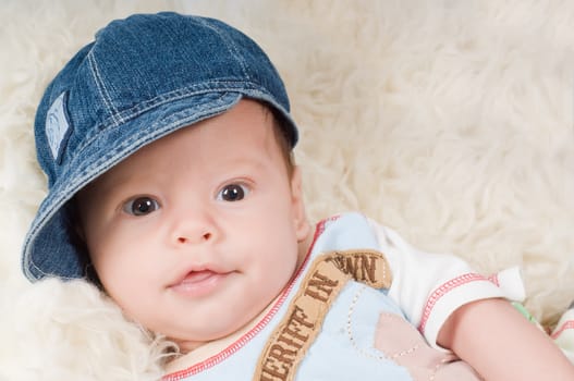 Shot of trendy newborn boy in denim cap