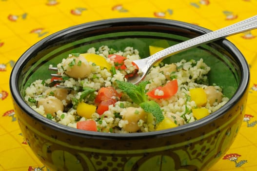 Close up of mediterranean couscous salad served in a Moroccan bowl