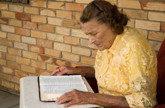 elder senior caucasian female reading Bible