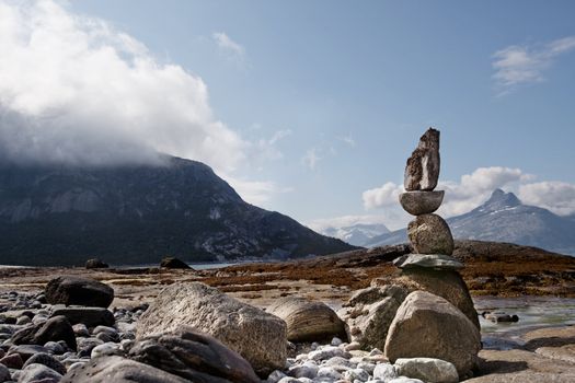 A rock sculpture statue on a Norwegian landscape