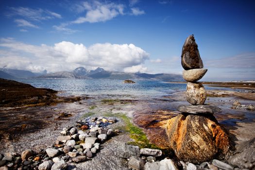 A rock stacking sculpture statue on a Norwegian landscape