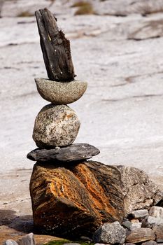 A rock stacking sculpture statue on a Norwegian landscape