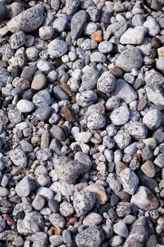 A surface texture of coastal small rocks - background surface