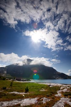 A coastal landscape in northern Norway with lens flare