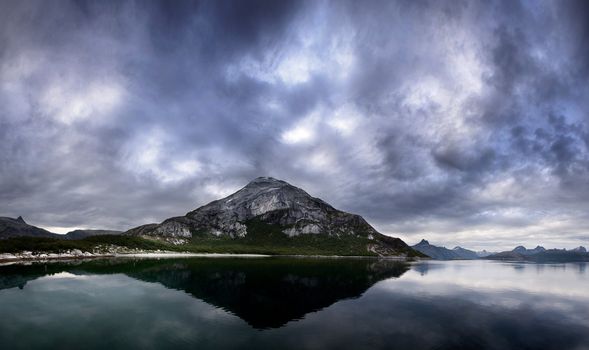 A landscape of a dramatic sky and mountain on the northern coast of Norway