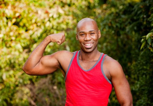 An African American man flexing his Bicep