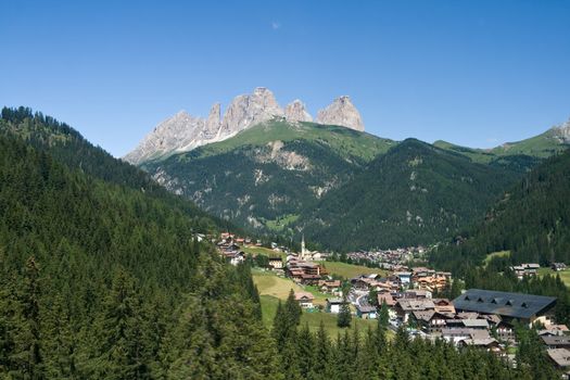 Aerial view of Alba di Canazei and Fassa valley with Sassolungo mount (Langkofel) behind.