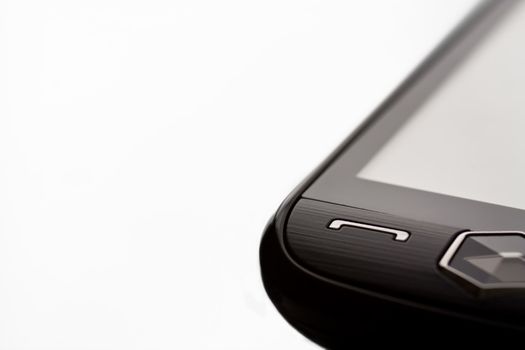 Close up of a touch screen cellular phone isolated on a white background with shallow depth of field