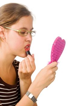 Woman applying lipstick to her lips 


