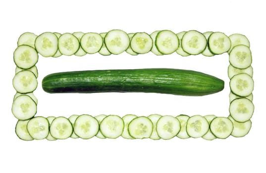The green long fresh and cut cucumber in a square.
One whole cucumber, another cut for an ornament of a dish.