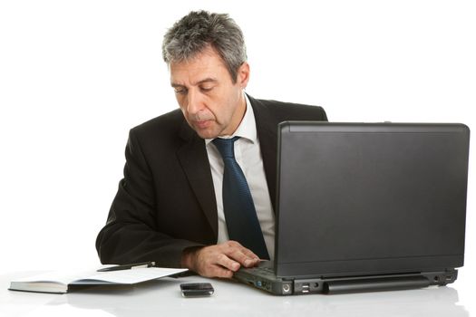 Senior business man working on laptop. Isolated on white