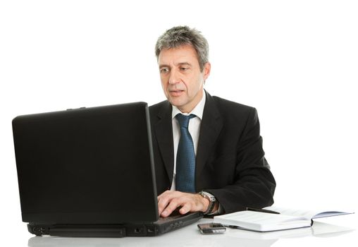 Senior business man working on laptop. Isolated on white