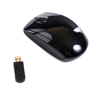 A black wireless mouse with a usb dongle, isolated against a white background