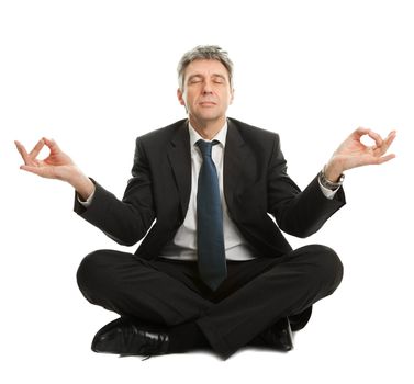 Businessman sitting in lotus flower position of yoga. Isolated on white